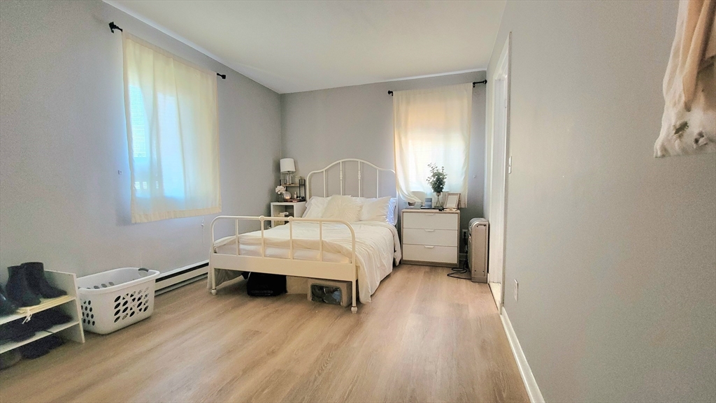 200 Kelton Street, Unit 14 Boston, MA 02134 - Photo 3 of 7 a bedroom with a bed and a window