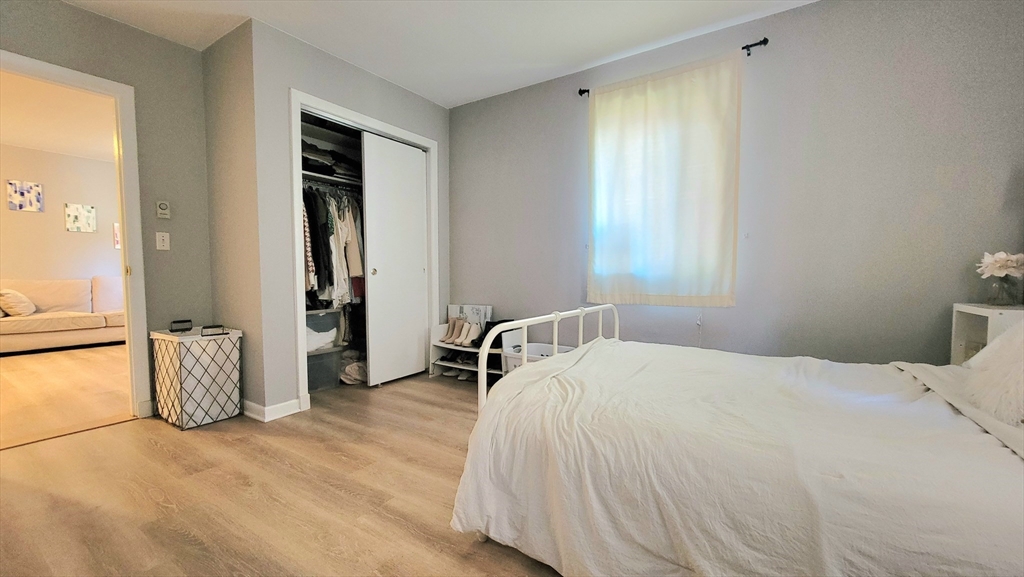 200 Kelton Street, Unit 14 Boston, MA 02134 - Photo 4 of 7 a bedroom with a bed and a window