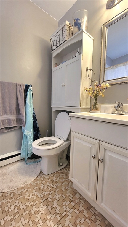 200 Kelton Street, Unit 14 Boston, MA 02134 - Photo 7 of 7 a bathroom with a toilet a sink and mirror