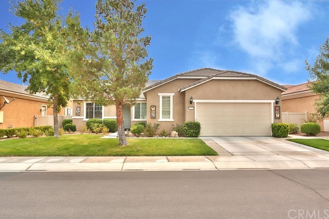 a front view of a house with a yard and a garage