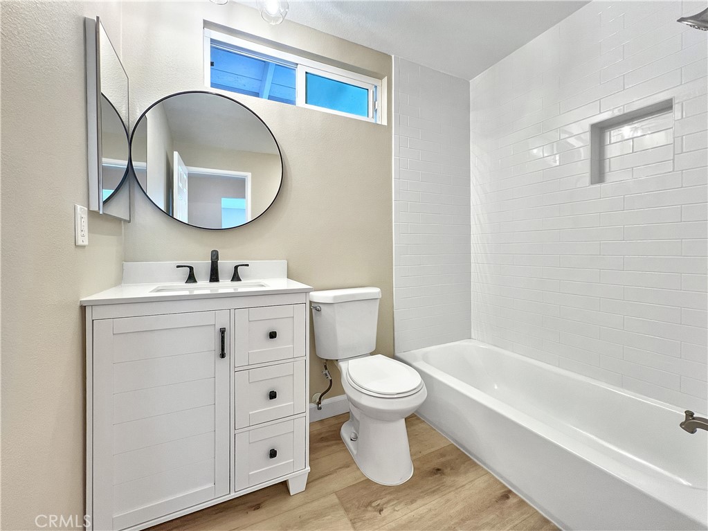 16941 Sims Lane, Unit B Huntington Beach, CA 92649 - Photo 7 of 12 Tub & Shower combination. This is a photo of Apt C. Apt B has a vinyl tub/shower.