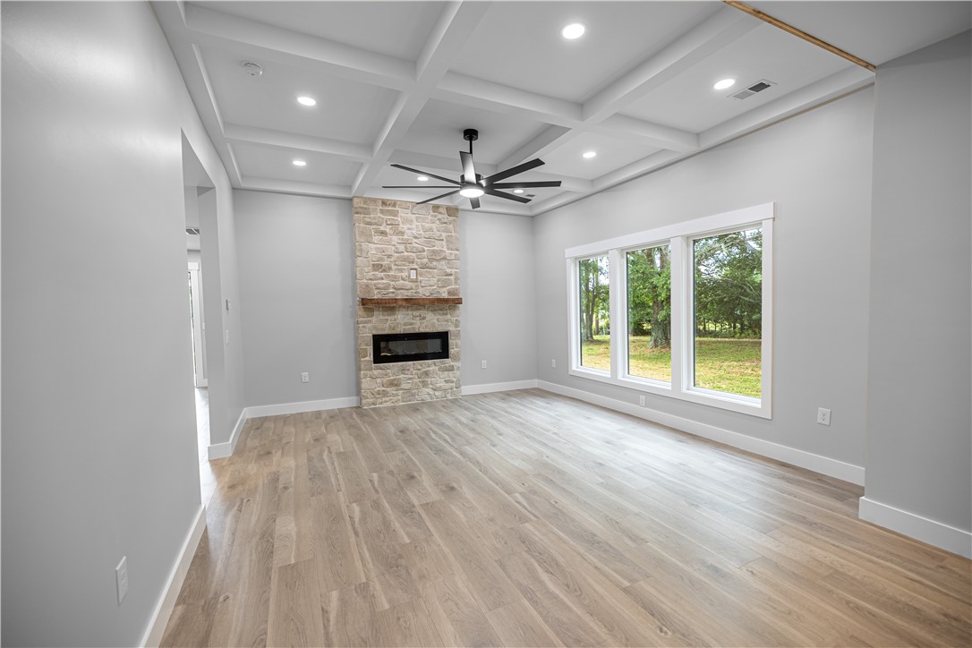 2817 Broadway Lake Road Anderson, SC 29621 - Photo 27 of 41 A spacious living area offers a striking stone fireplace, wide windows, and decorative coffered ceilings.