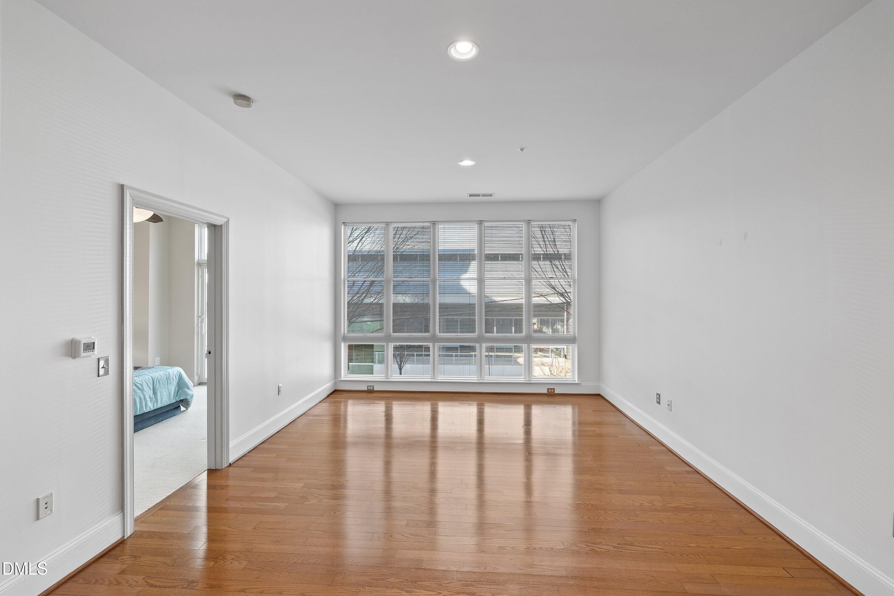 317 West Morgan Street, Unit 215 Raleigh, NC 27601 - Photo 15 of 38 wooden floor in an empty room with a window