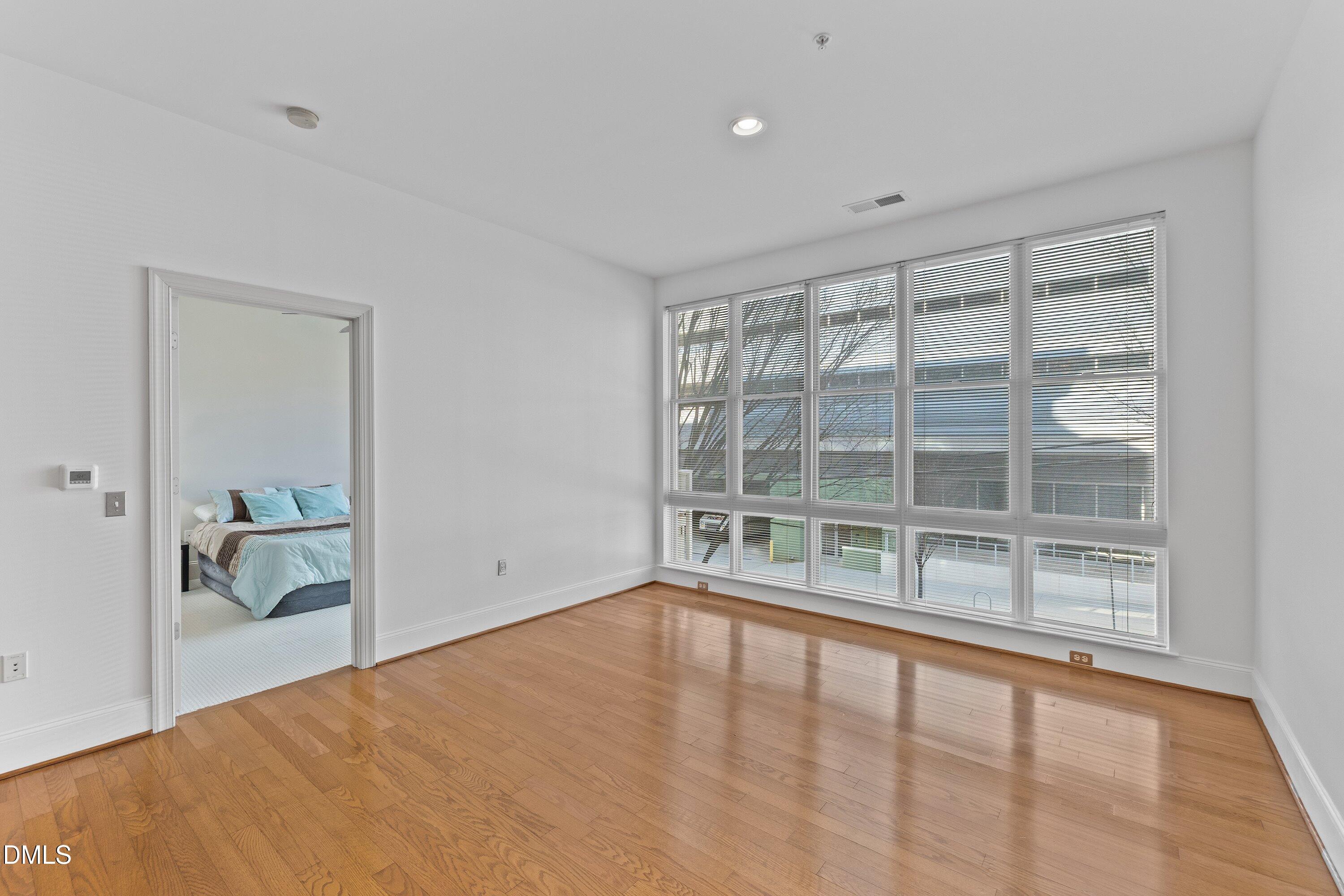 317 West Morgan Street, Unit 215 Raleigh, NC 27601 - Photo 16 of 38 a view of an empty room with a window