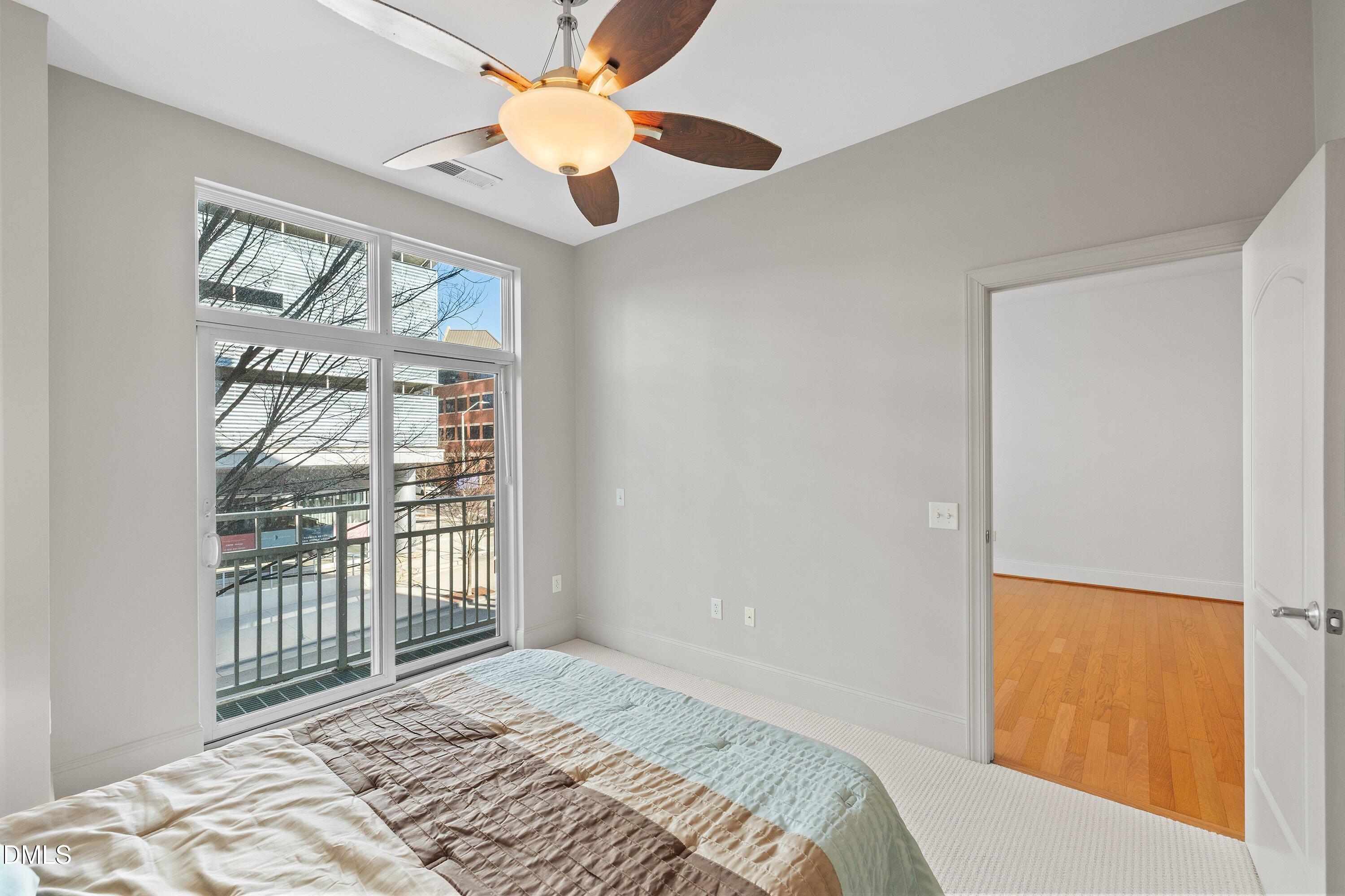 317 West Morgan Street, Unit 215 Raleigh, NC 27601 - Photo 17 of 38 a bedroom with a bed and a window