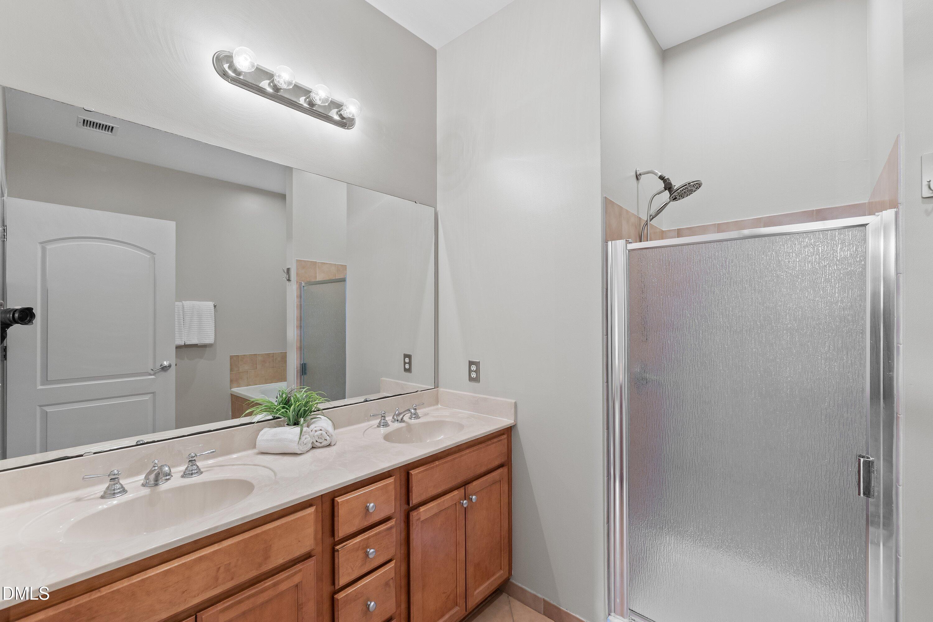 317 West Morgan Street, Unit 215 Raleigh, NC 27601 - Photo 20 of 38 a bathroom with a granite countertop sink mirror and double