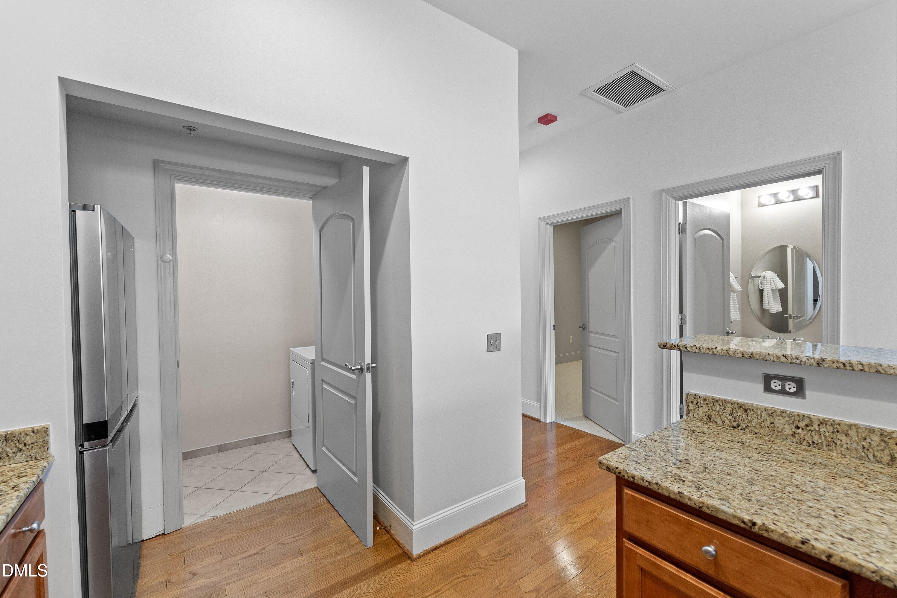 317 West Morgan Street, Unit 215 Raleigh, NC 27601 - Photo 9 of 38 a bathroom with a granite countertop sink and a mirror