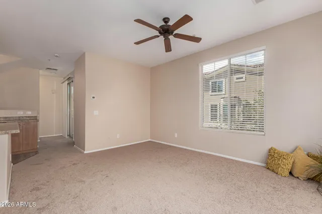 a view of livingroom with a ceiling fan and window