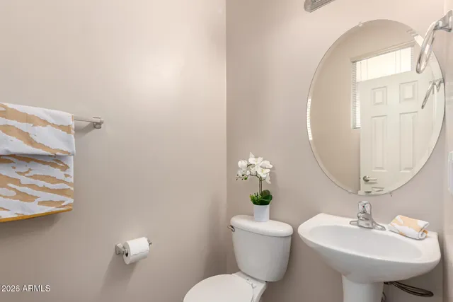 a bathroom with a sink toilet and mirror