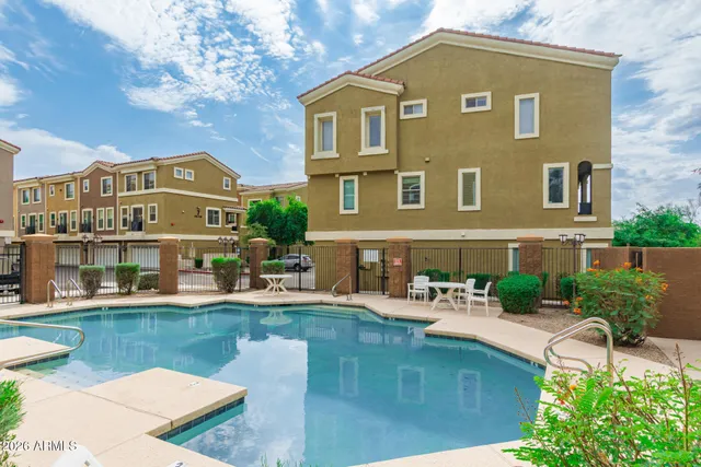 a front view of a house with swimming pool having outdoor seating