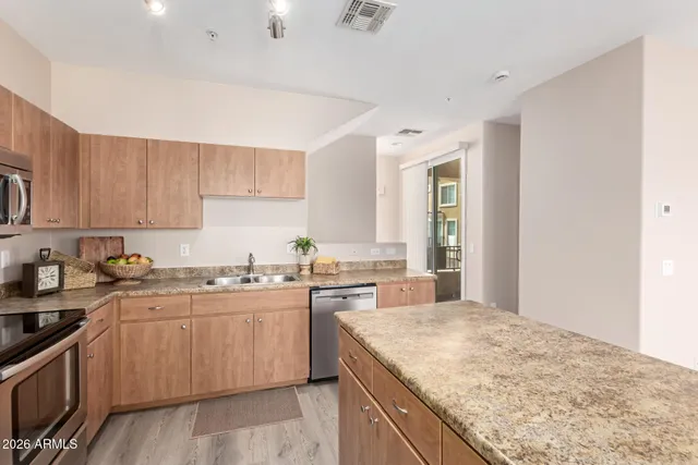 a kitchen with a sink stove and cabinets