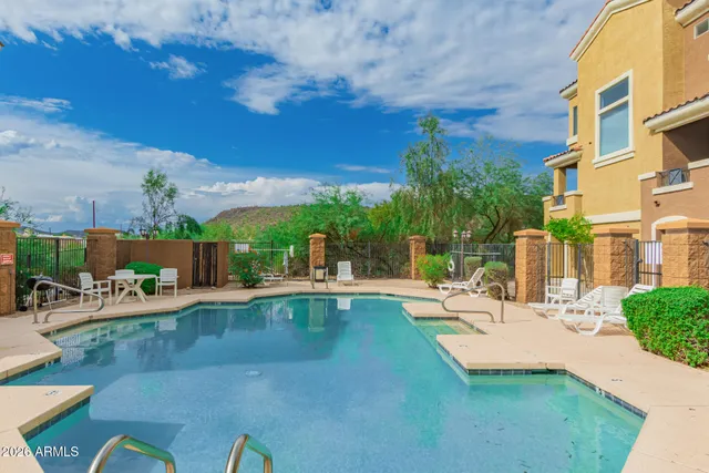 a view of a swimming pool with outdoor seating