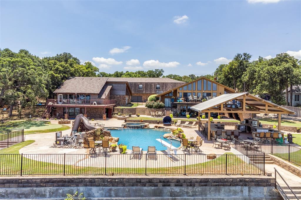 View of pool with a gazebo, a water slide, an in ground hot tub, and a patio