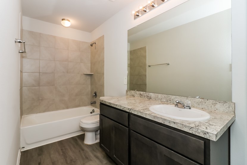 21626 Mamba Way Houston, TX 77073 - Photo 11 of 12 a bathroom with a granite countertop sink a toilet and bathtub