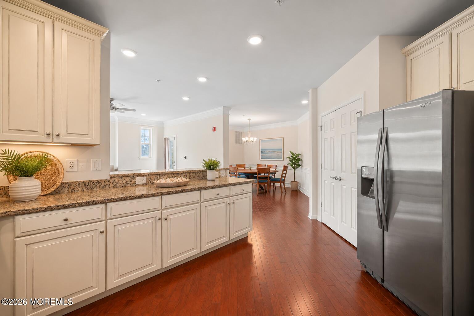 2201 River Road, Unit 4207 Point Pleasant, NJ 08742 - Photo 7 of 34 a kitchen with stainless steel appliances granite countertop a refrigerator a sink dishwasher and white cabinets with wooden floor