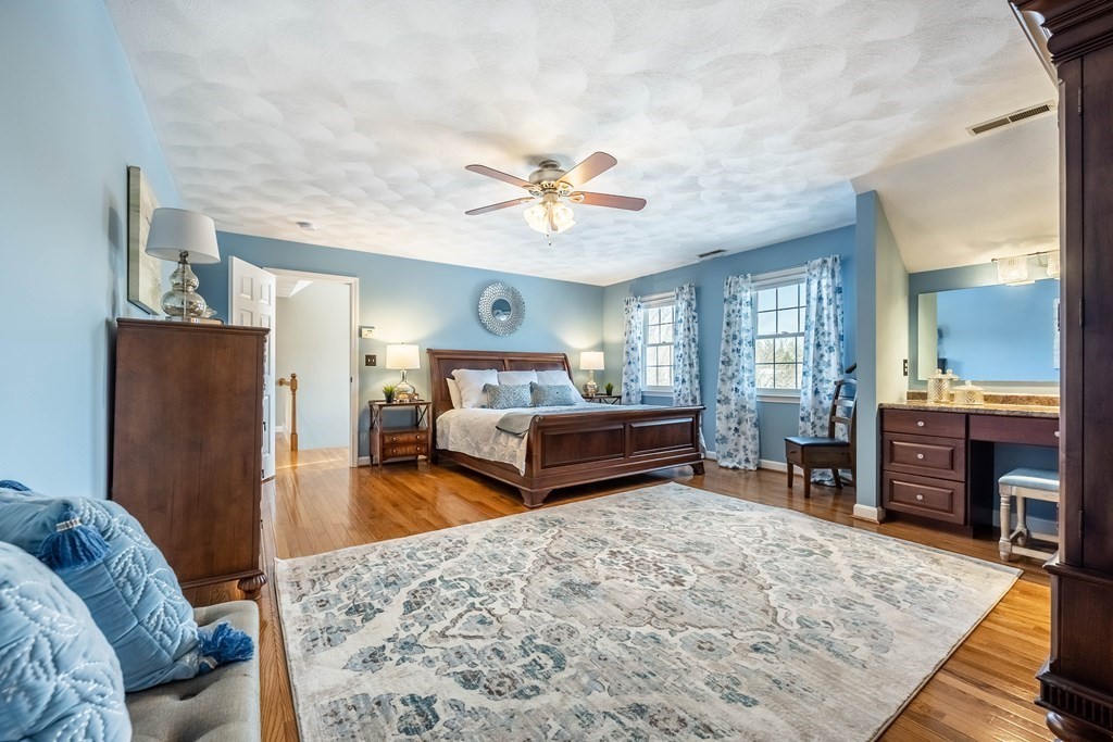 5 Devonshire Place Andover, MA 01810 - Photo 21 of 42 a bedroom with furniture and a wooden floor