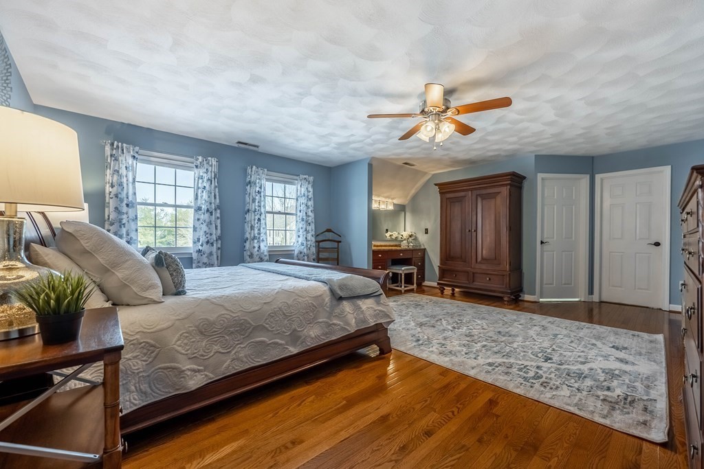 5 Devonshire Place Andover, MA 01810 - Photo 22 of 42 a bedroom with a large bed a chandelier and dresser