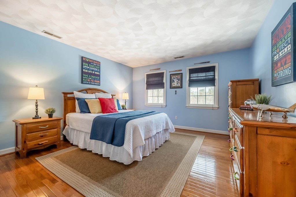 5 Devonshire Place Andover, MA 01810 - Photo 28 of 42 a bedroom with a bed and a dresser