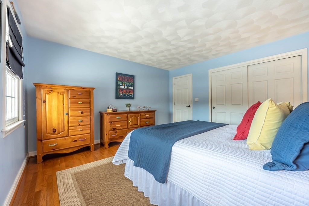 5 Devonshire Place Andover, MA 01810 - Photo 29 of 42 a bedroom with a bed and wooden floor