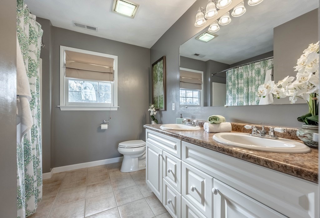5 Devonshire Place Andover, MA 01810 - Photo 33 of 42 a bathroom with a double vanity sink a toilet and a mirror