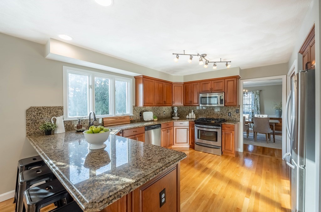 5 Devonshire Place Andover, MA 01810 - Photo 7 of 42 a kitchen with granite countertop lots of counter top space and dining table
