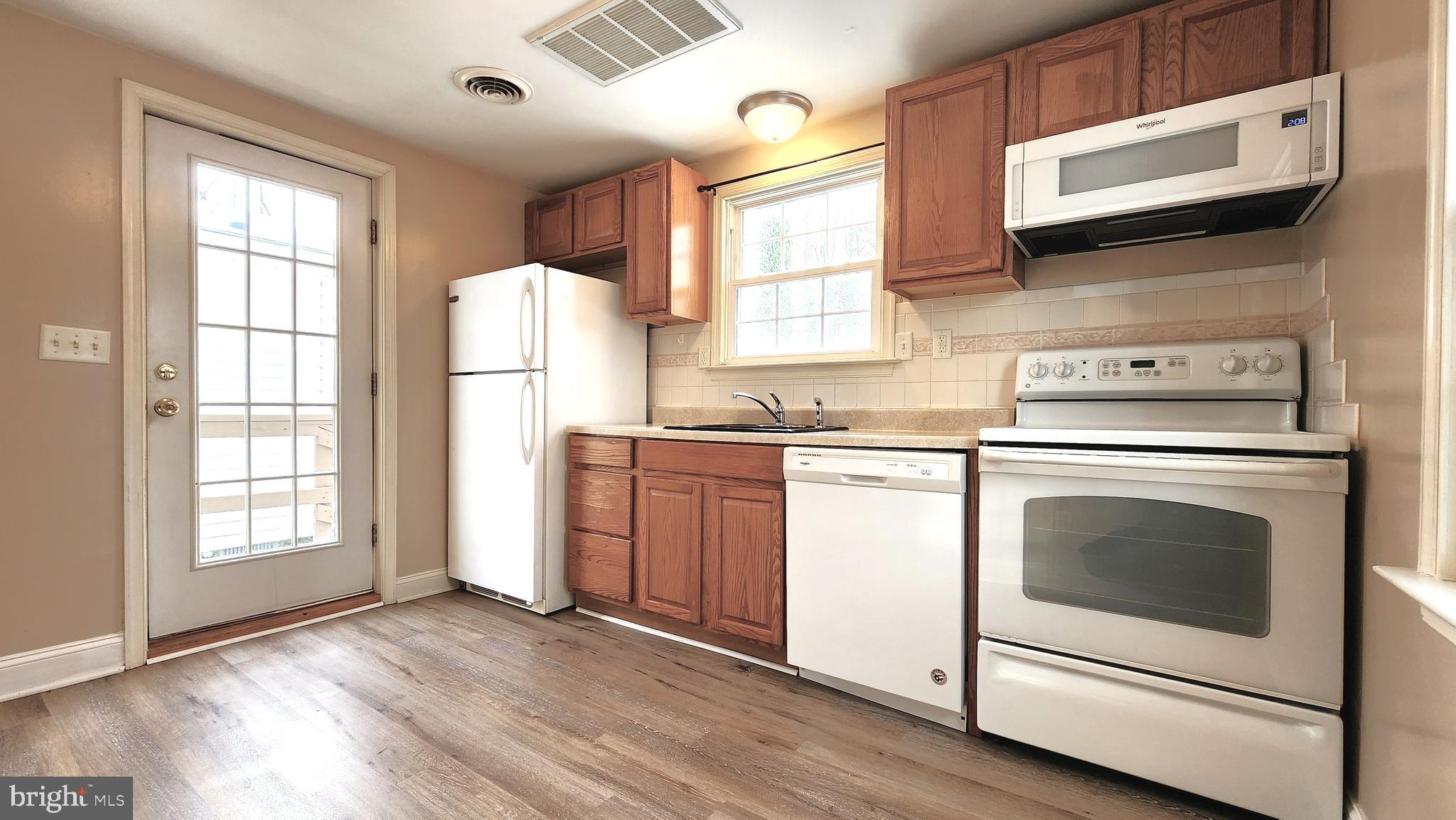 1122 Horsepond Road Dover, DE 19901 - Photo 11 of 26 a kitchen with a stove microwave and window