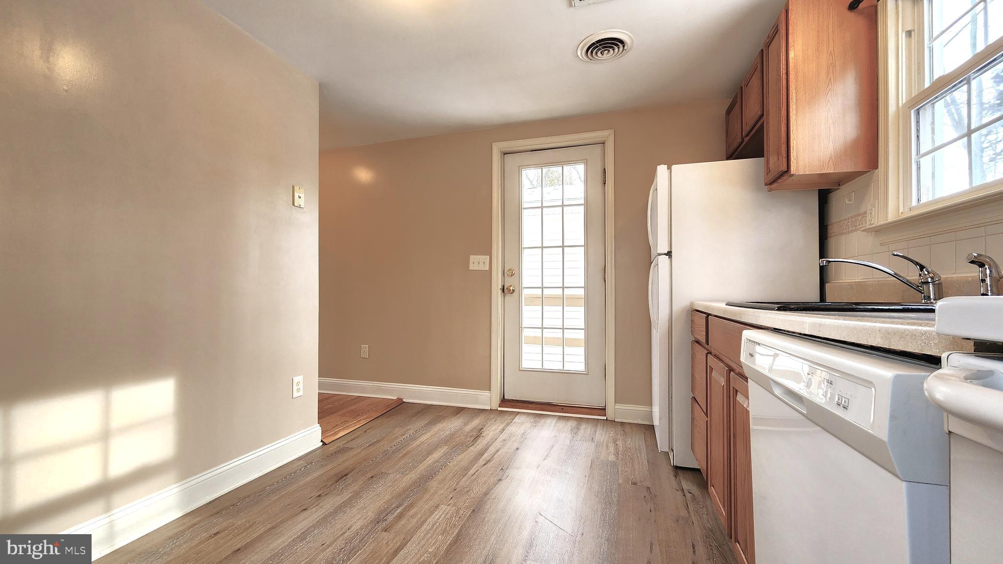 1122 Horsepond Road Dover, DE 19901 - Photo 12 of 26 a kitchen with a wooden floor and a window