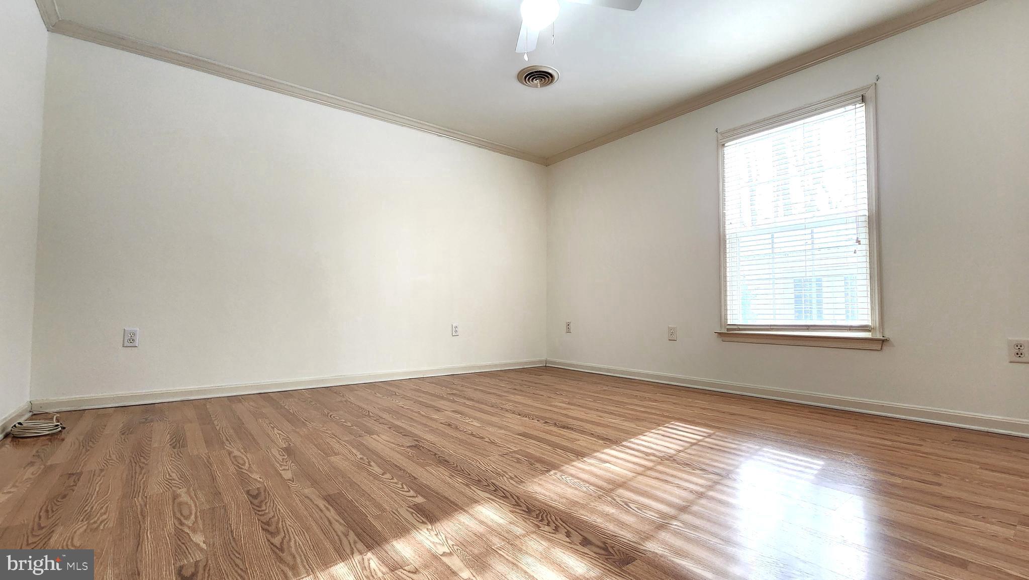1122 Horsepond Road Dover, DE 19901 - Photo 16 of 26 an empty room with wooden floor and windows