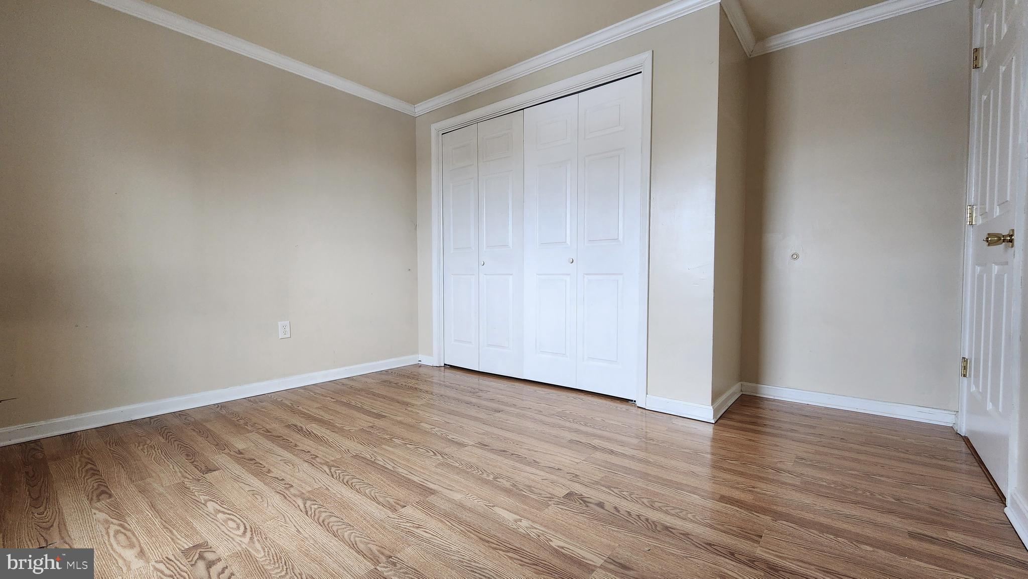 1122 Horsepond Road Dover, DE 19901 - Photo 19 of 26 a view of an empty room with wooden floor and closet