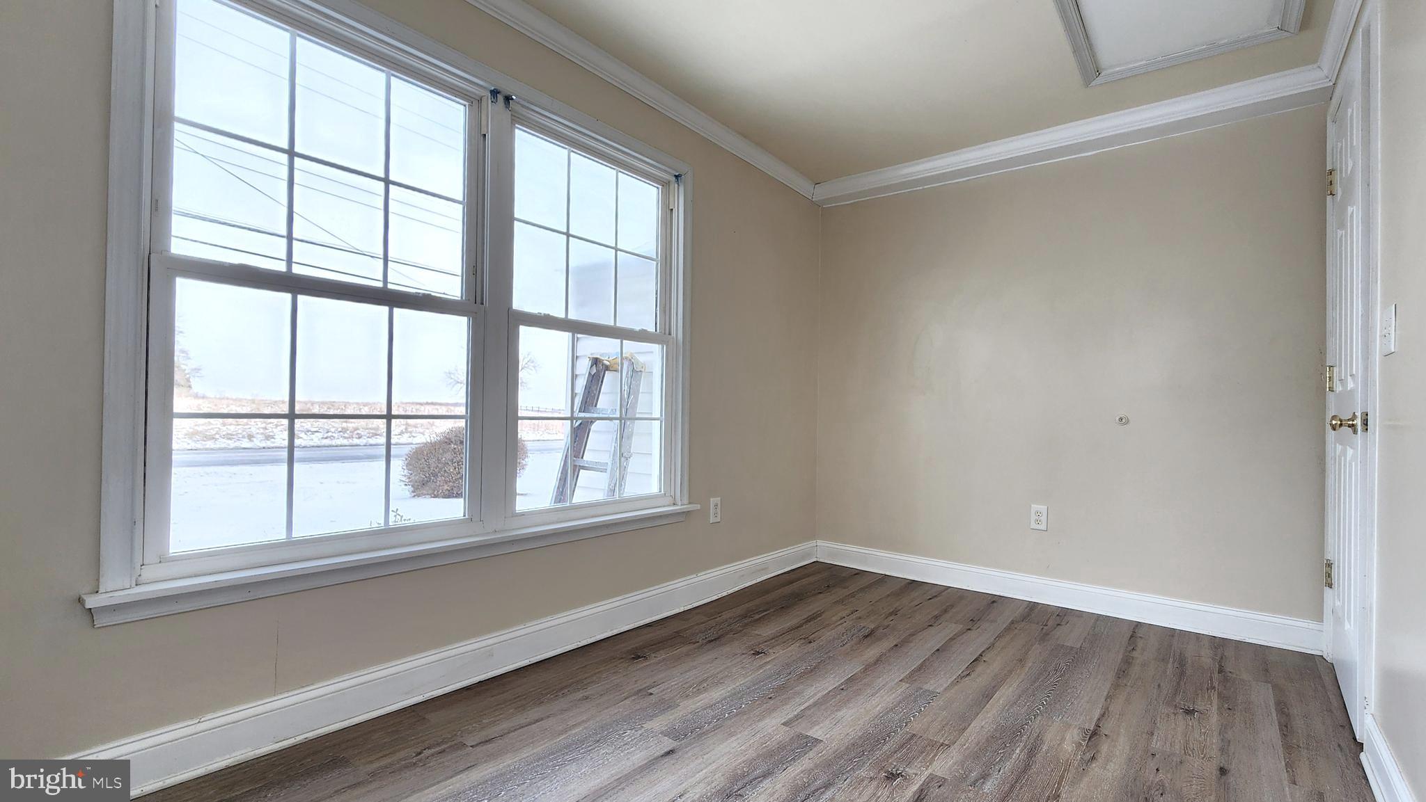 1122 Horsepond Road Dover, DE 19901 - Photo 23 of 26 an empty room with wooden floor and windows