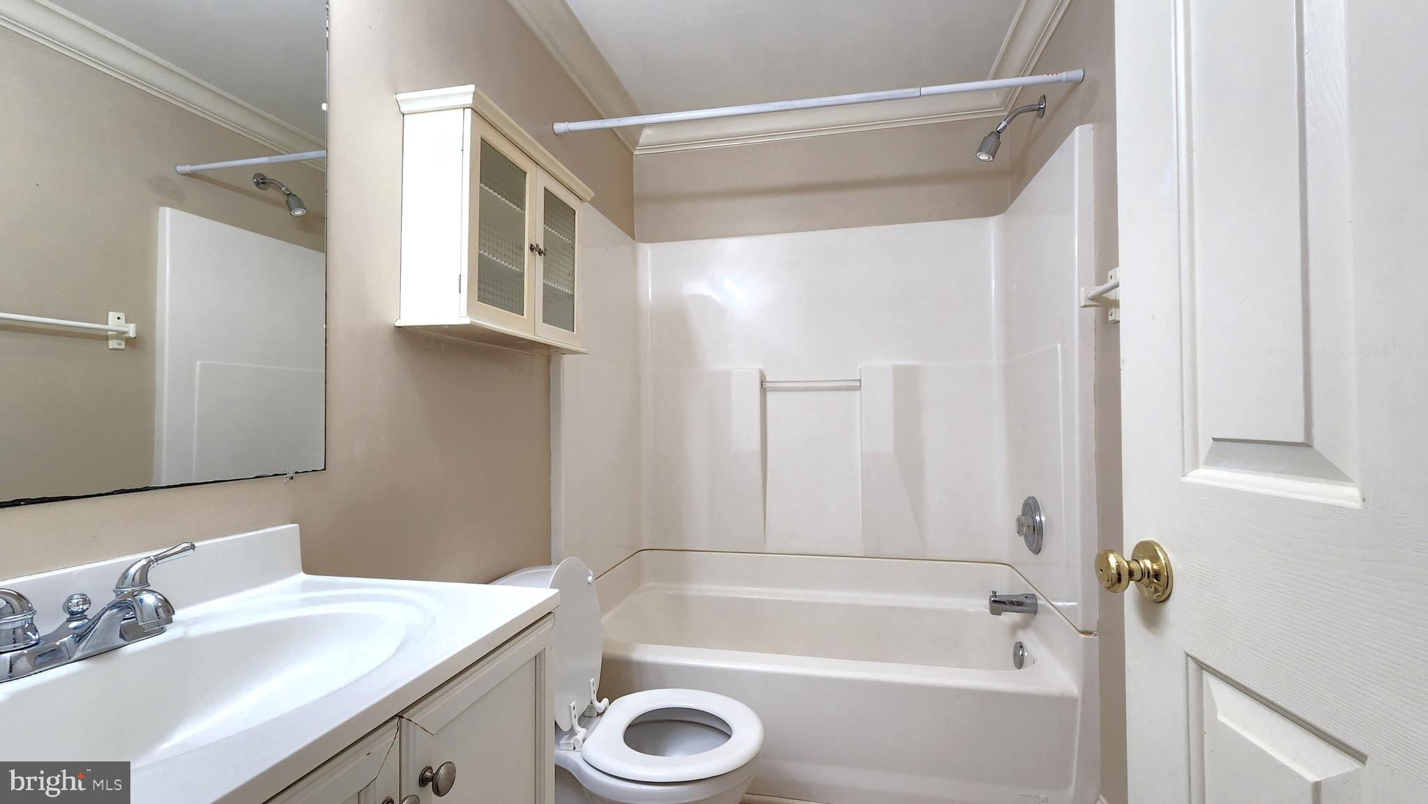 1122 Horsepond Road Dover, DE 19901 - Photo 24 of 26 a bathroom with a tub a sink and a large mirror