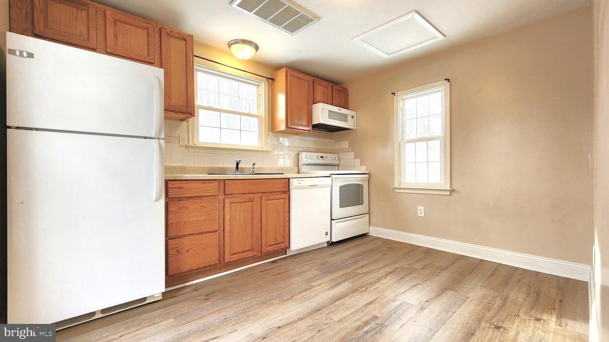 1122 Horsepond Road Dover, DE 19901 - Photo 10 of 26 a kitchen with a white cabinets and white appliances