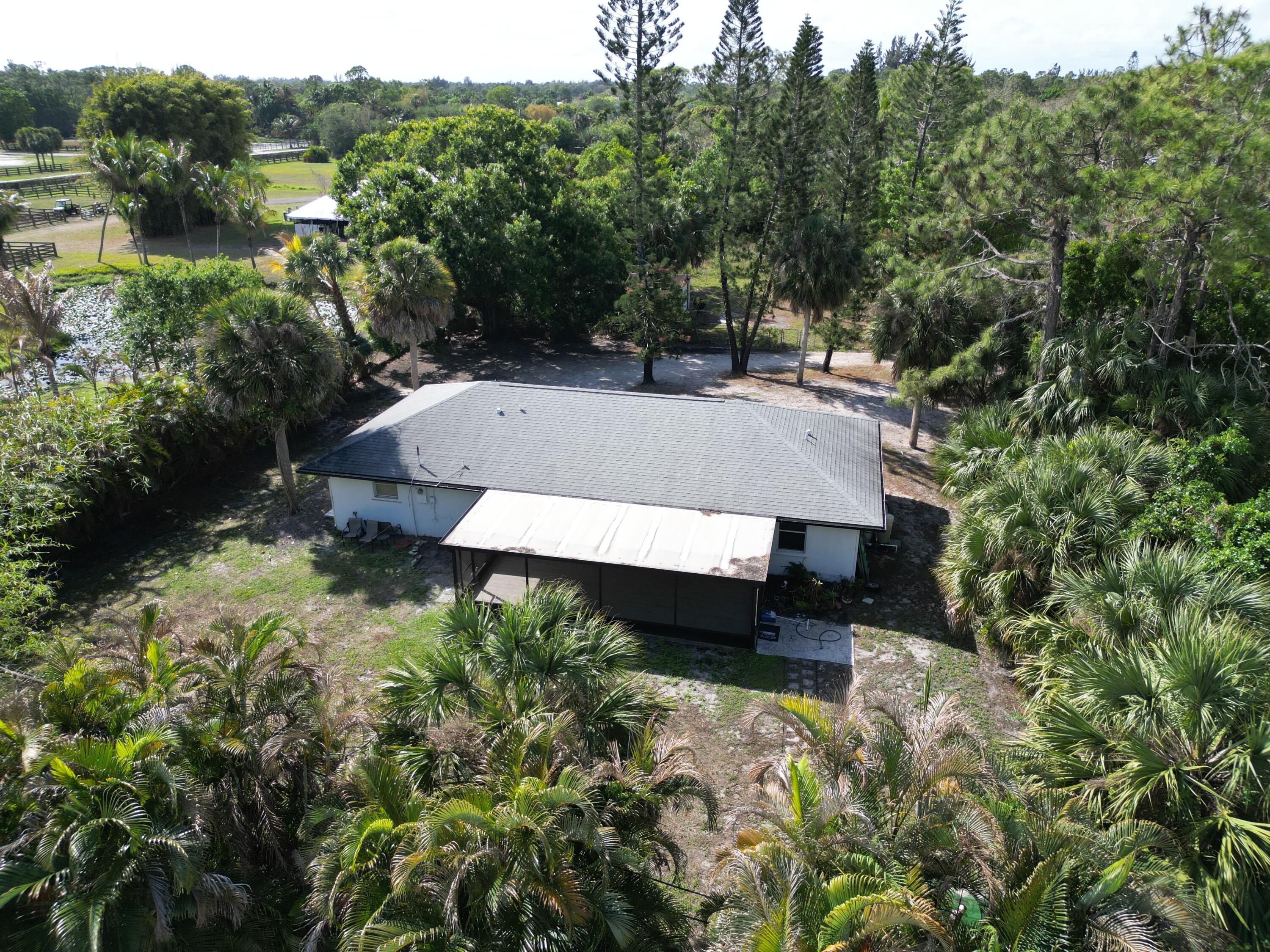14523 Flamingo Road Loxahatchee Groves, FL 33470 - Photo 23 of 50 an aerial view of a house with pool and a yard