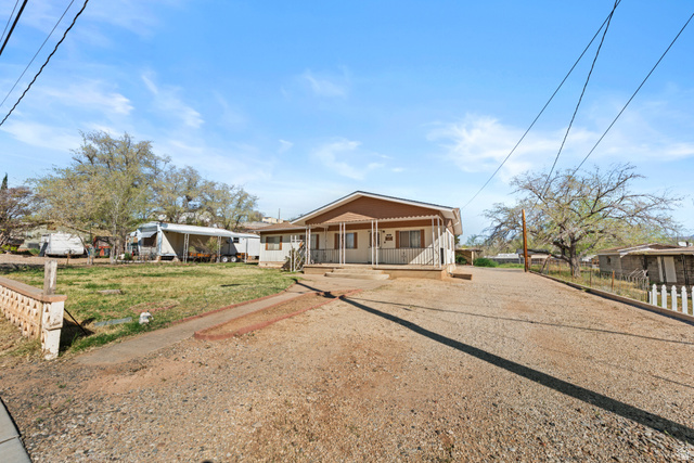 49 600 North Hurricane, UT 84737 - Photo 26 of 33 View of front facade with covered porch and dirt driveway
