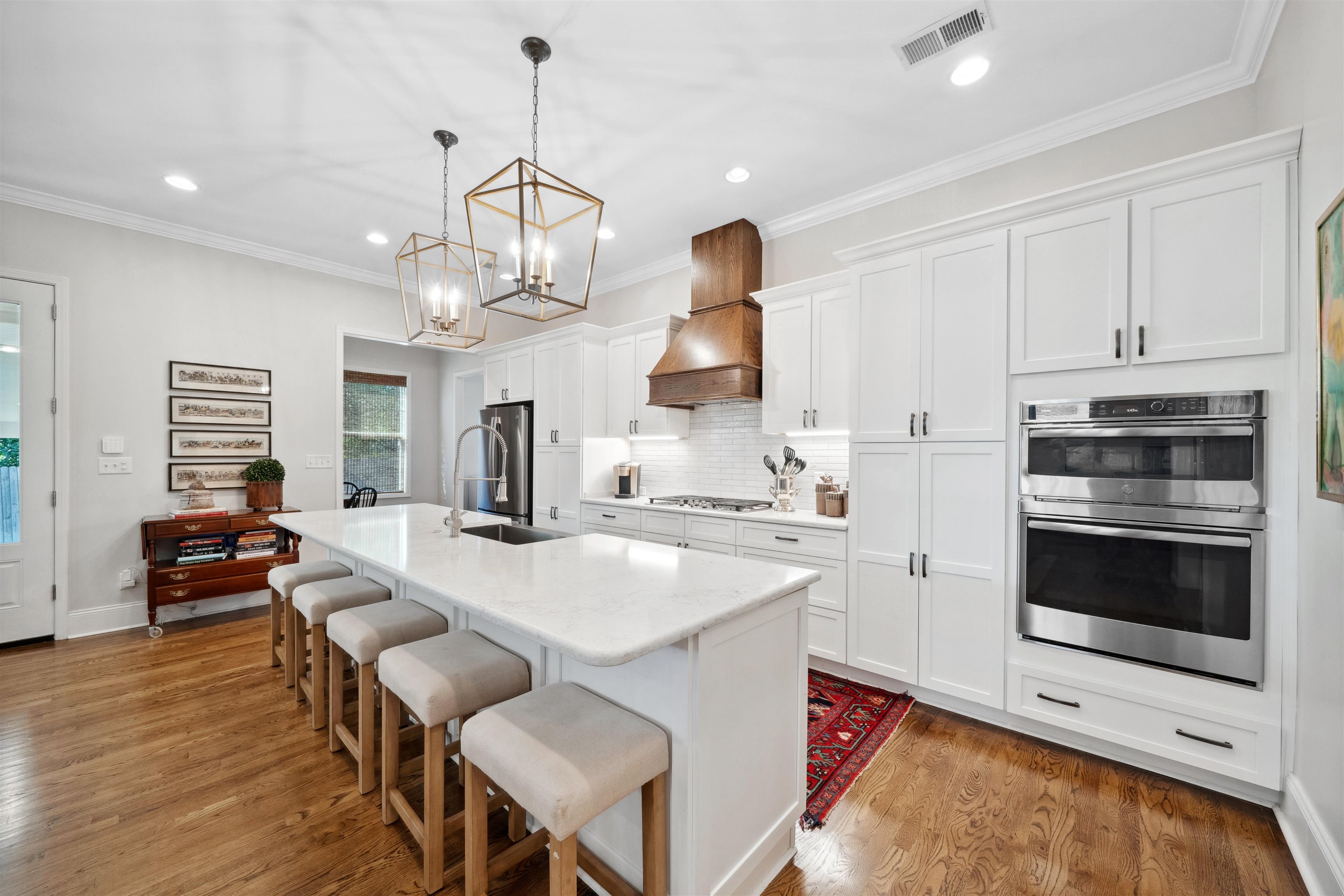 3794 Rosedale Drive Memphis, TN 38111 - Photo 12 of 33 Kitchen featuring stainless steel appliances, a sink, a kitchen island with sink, a breakfast bar, and white cabinetry