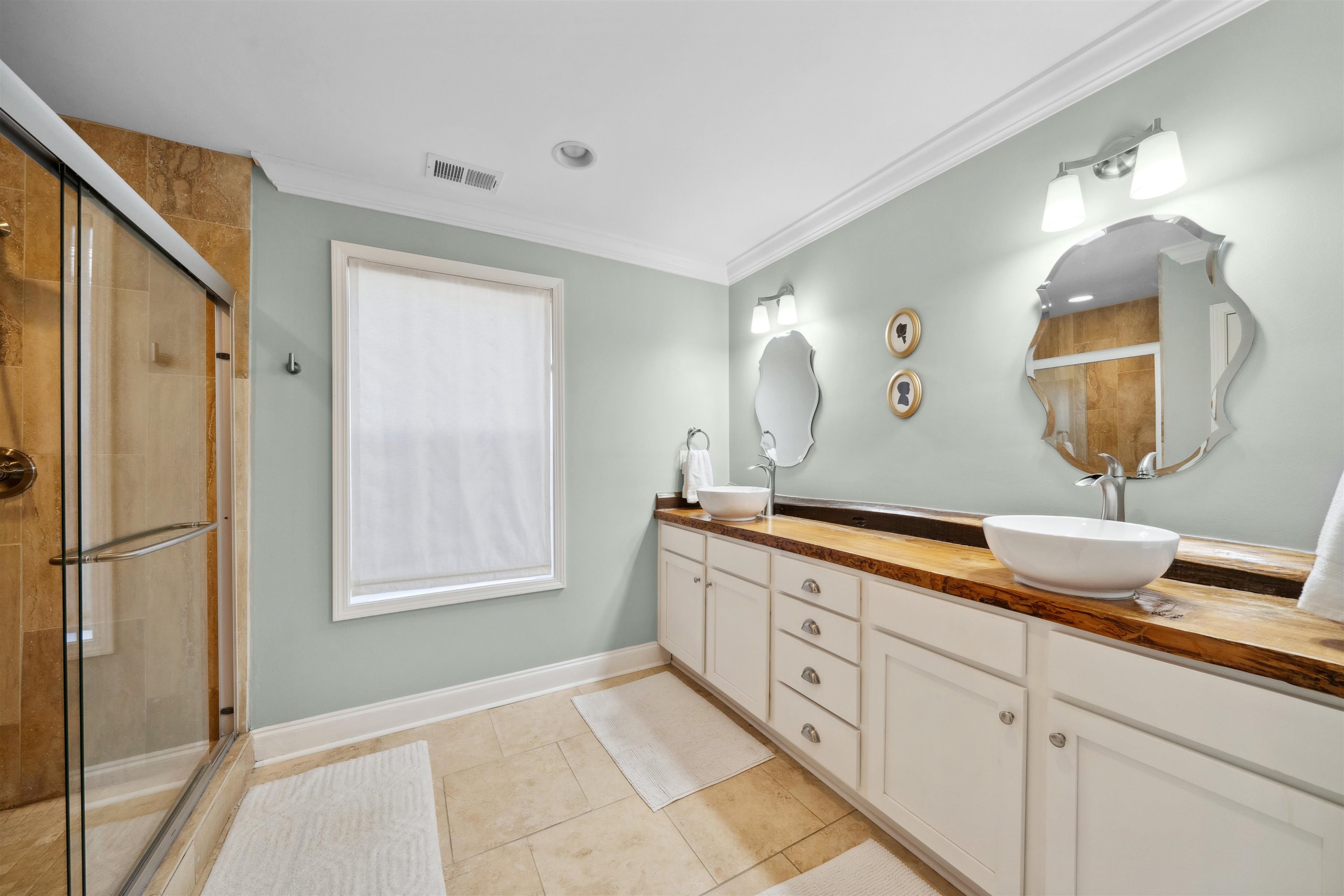 3794 Rosedale Drive Memphis, TN 38111 - Photo 18 of 33 Bathroom featuring double vanity, tiled shower, crown molding, tile patterned floors, and baseboards