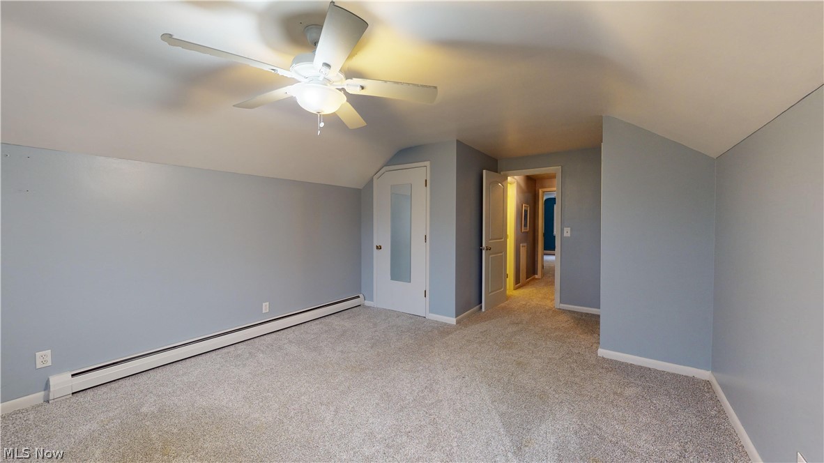 12326 Huntoon Road Painesville, OH 44077 - Photo 27 of 38 Bonus room with light carpet, ceiling fan, lofted ceiling, and baseboard heating