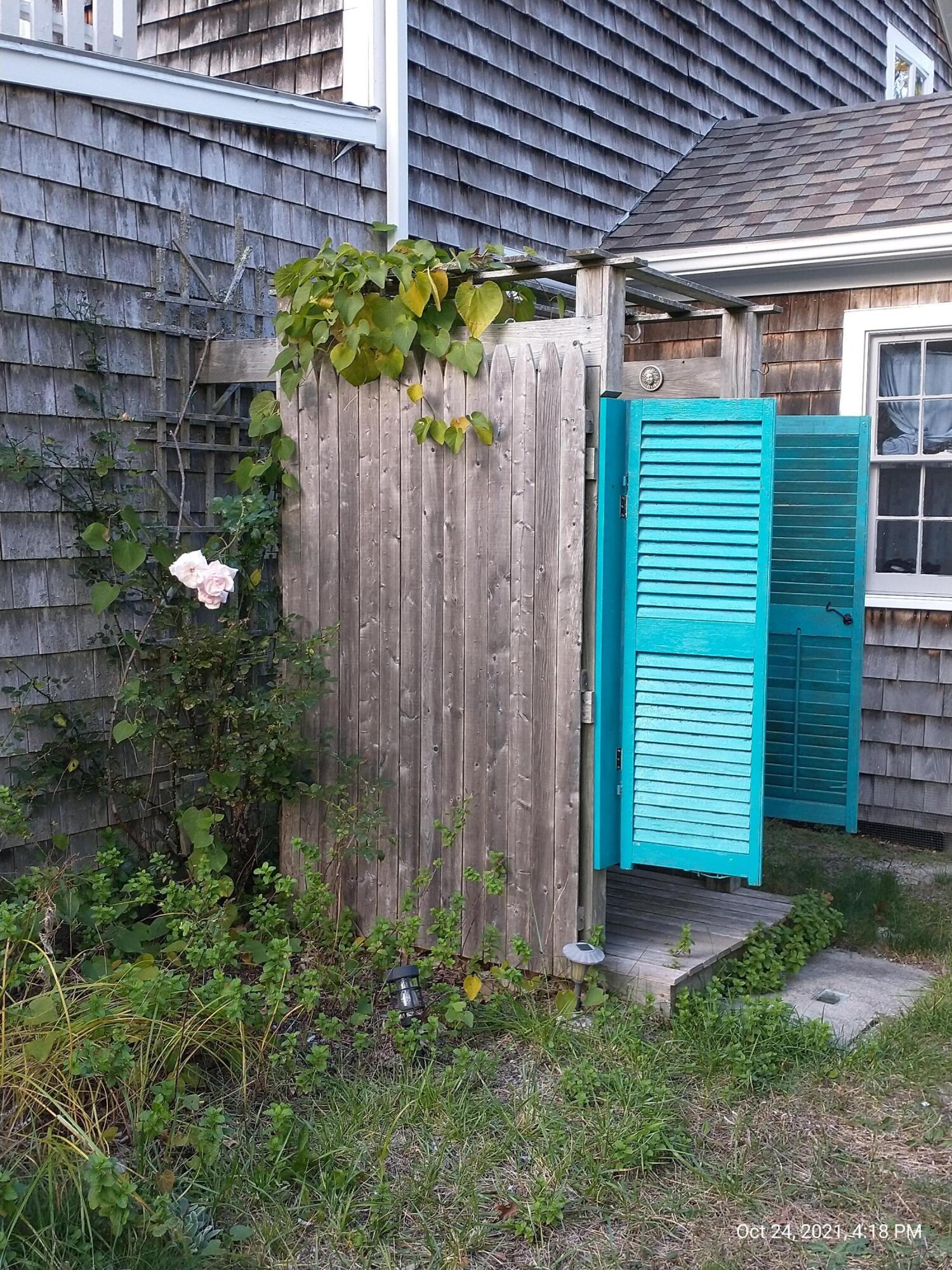 122 Gull Pond Road Wellfleet, MA 02667 - Photo 18 of 26 a front view of a house with a garden