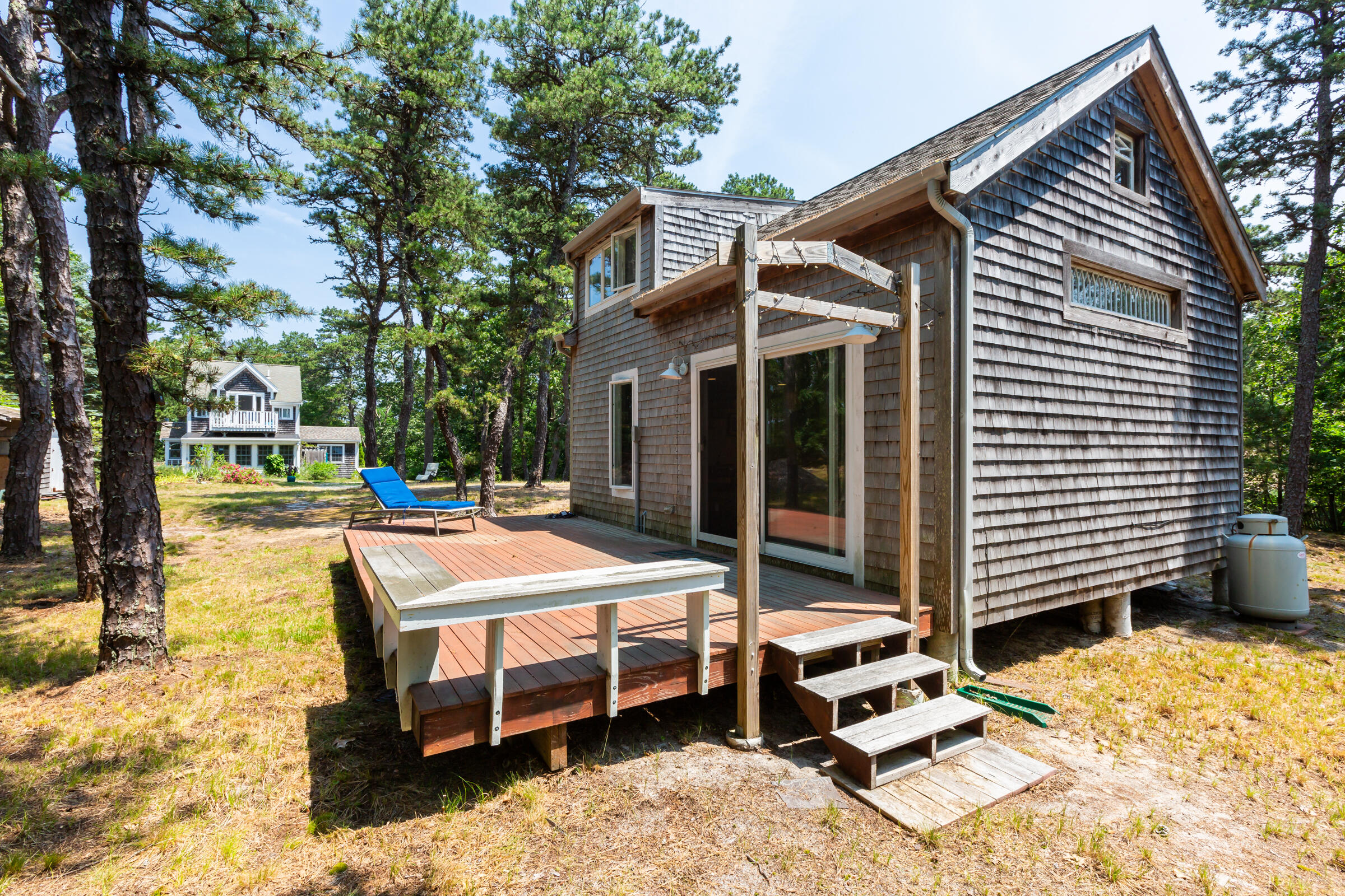 122 Gull Pond Road Wellfleet, MA 02667 - Photo 19 of 26 a backyard of a house with barbeque oven table and chairs
