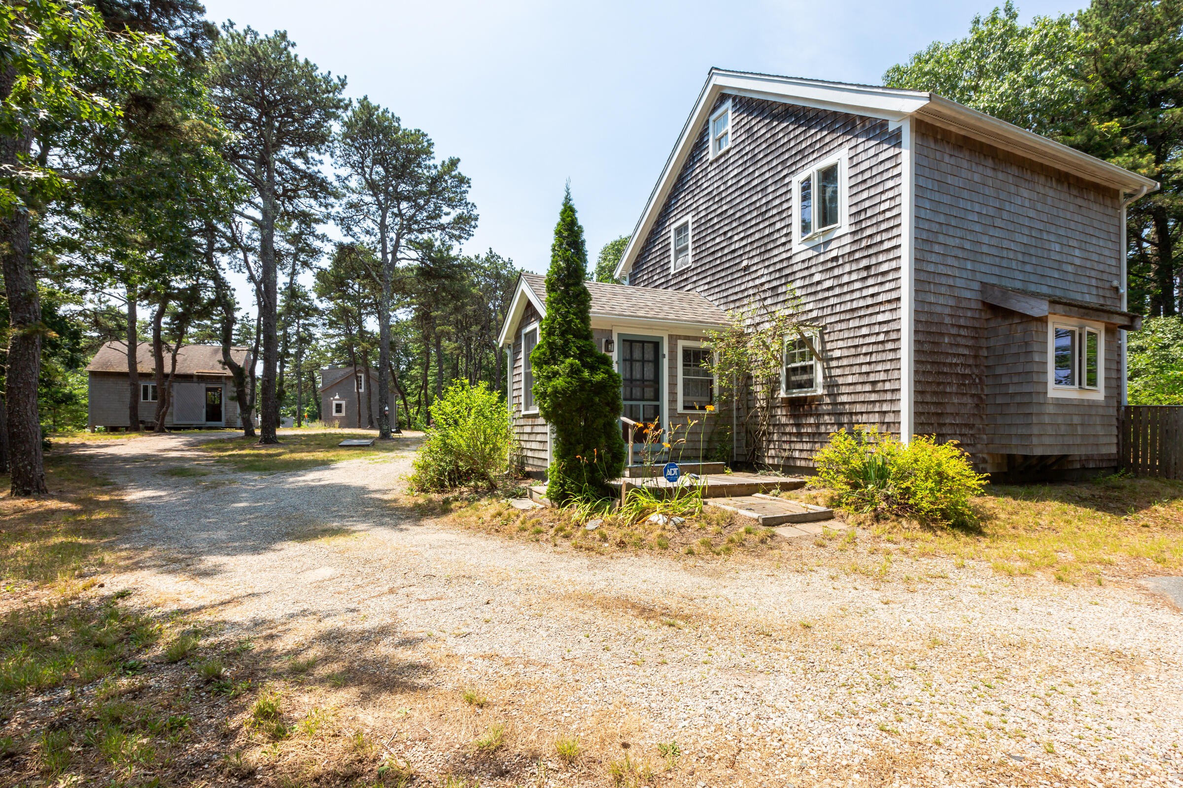 122 Gull Pond Road Wellfleet, MA 02667 - Photo 2 of 26 a front view of a house with a yard