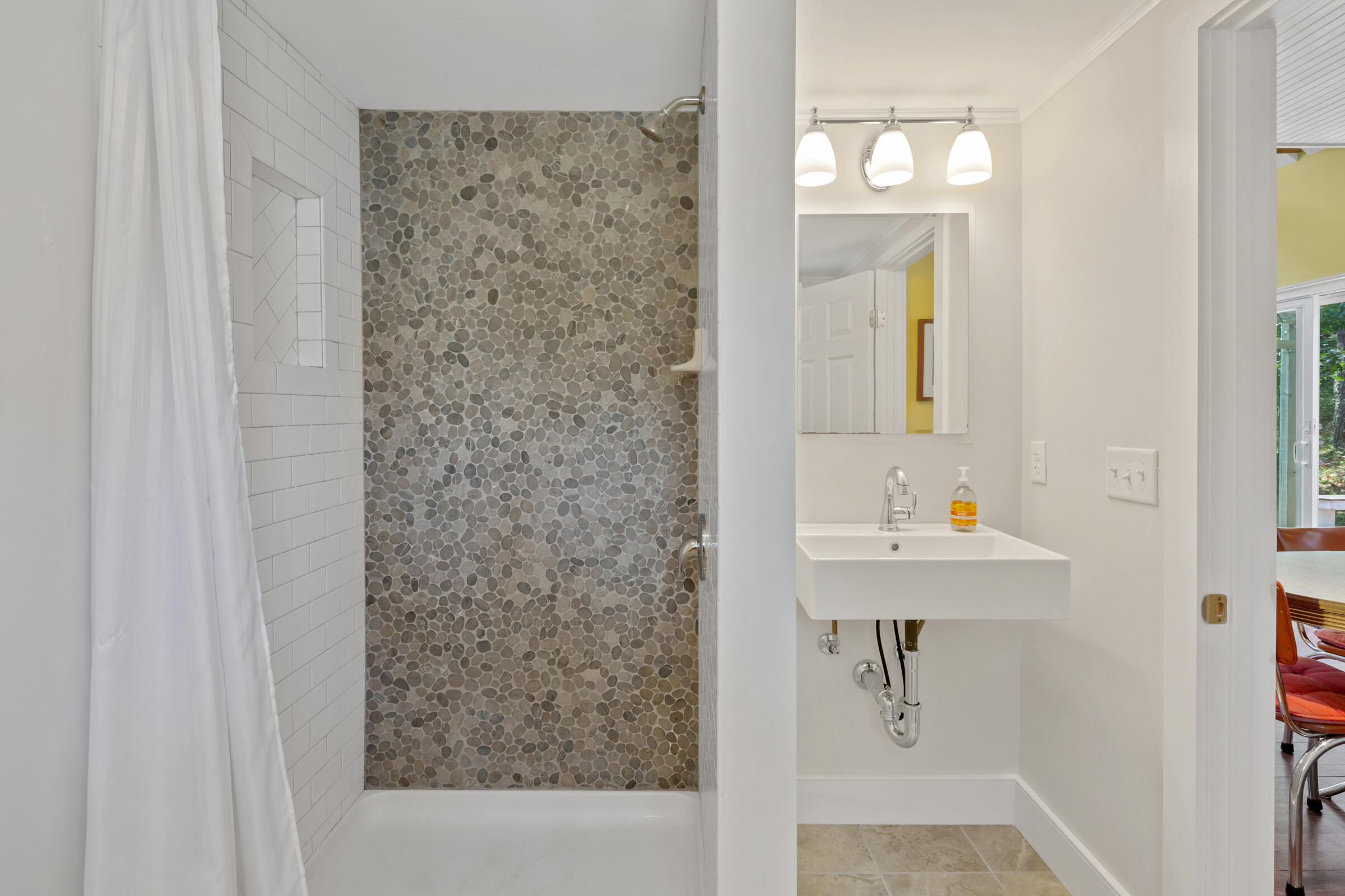 122 Gull Pond Road Wellfleet, MA 02667 - Photo 21 of 26 a bathroom with a sink a mirror and a shower