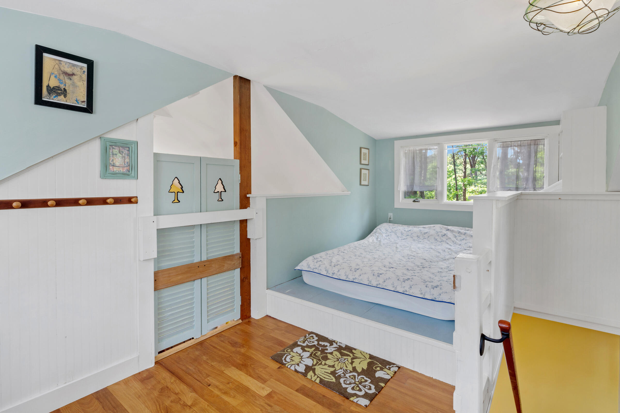 122 Gull Pond Road Wellfleet, MA 02667 - Photo 22 of 26 a bedroom with a bed and a dresser next to a window
