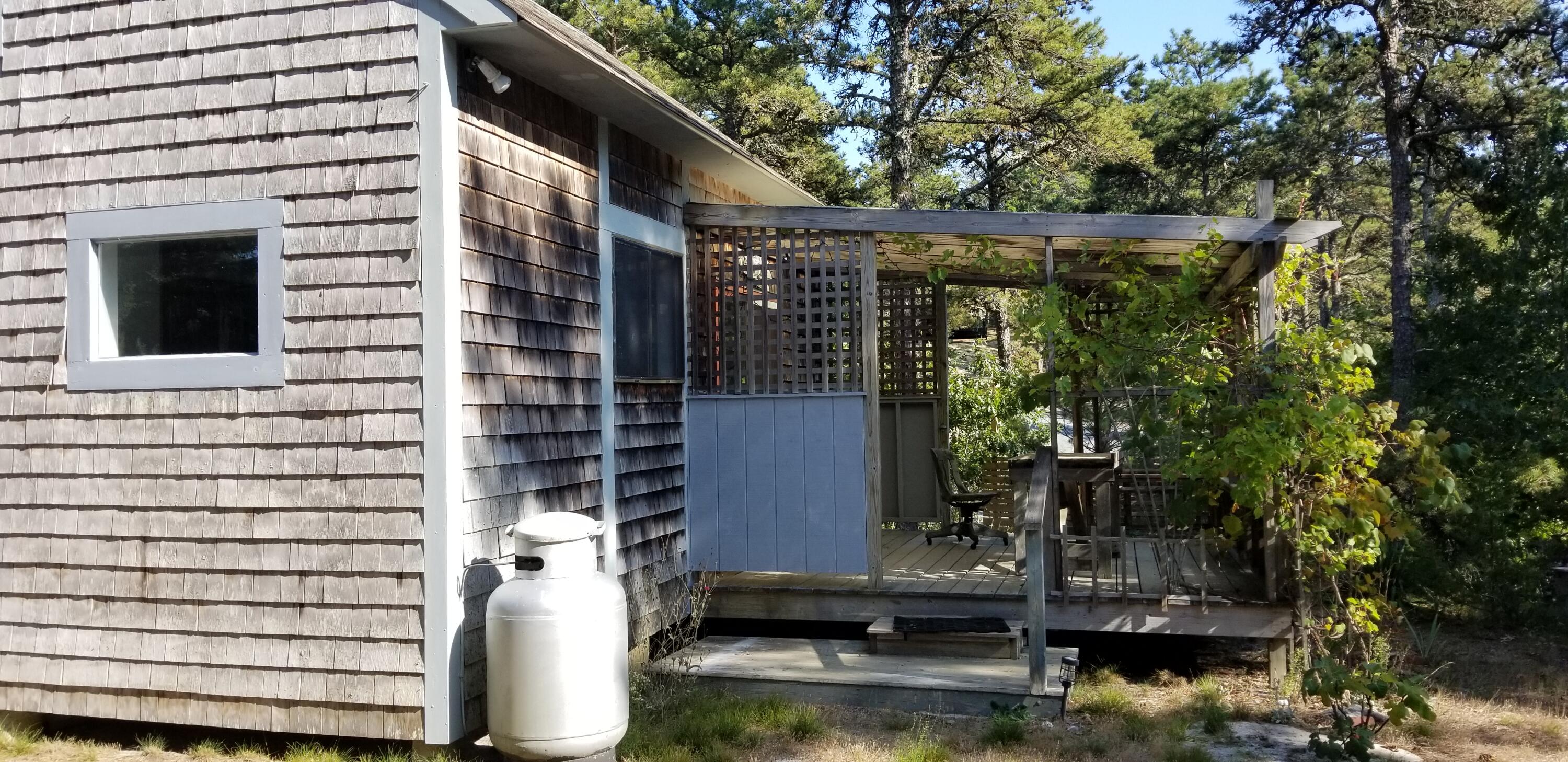 122 Gull Pond Road Wellfleet, MA 02667 - Photo 25 of 26 a backyard of a house with outdoor seating