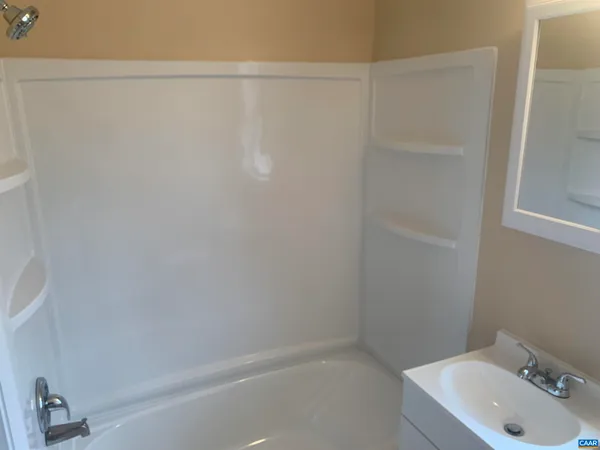 a bathroom with a sink and shower
