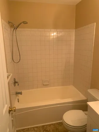 a bathroom with a toilet and shower