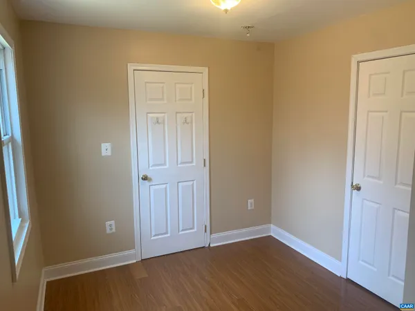 an empty room with wooden floor