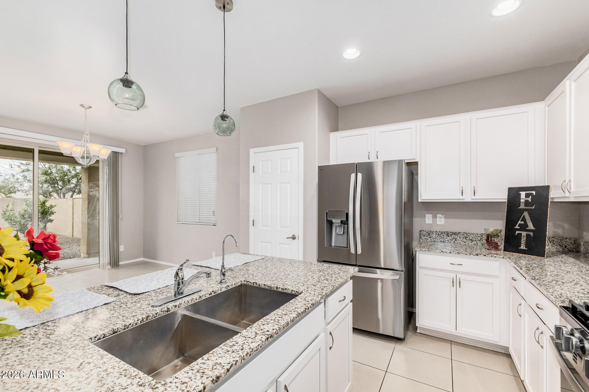 4228 West Coles Road Laveen, AZ 85339 - Photo 11 of 36 a kitchen with stainless steel appliances granite countertop a sink a stove and a refrigerator