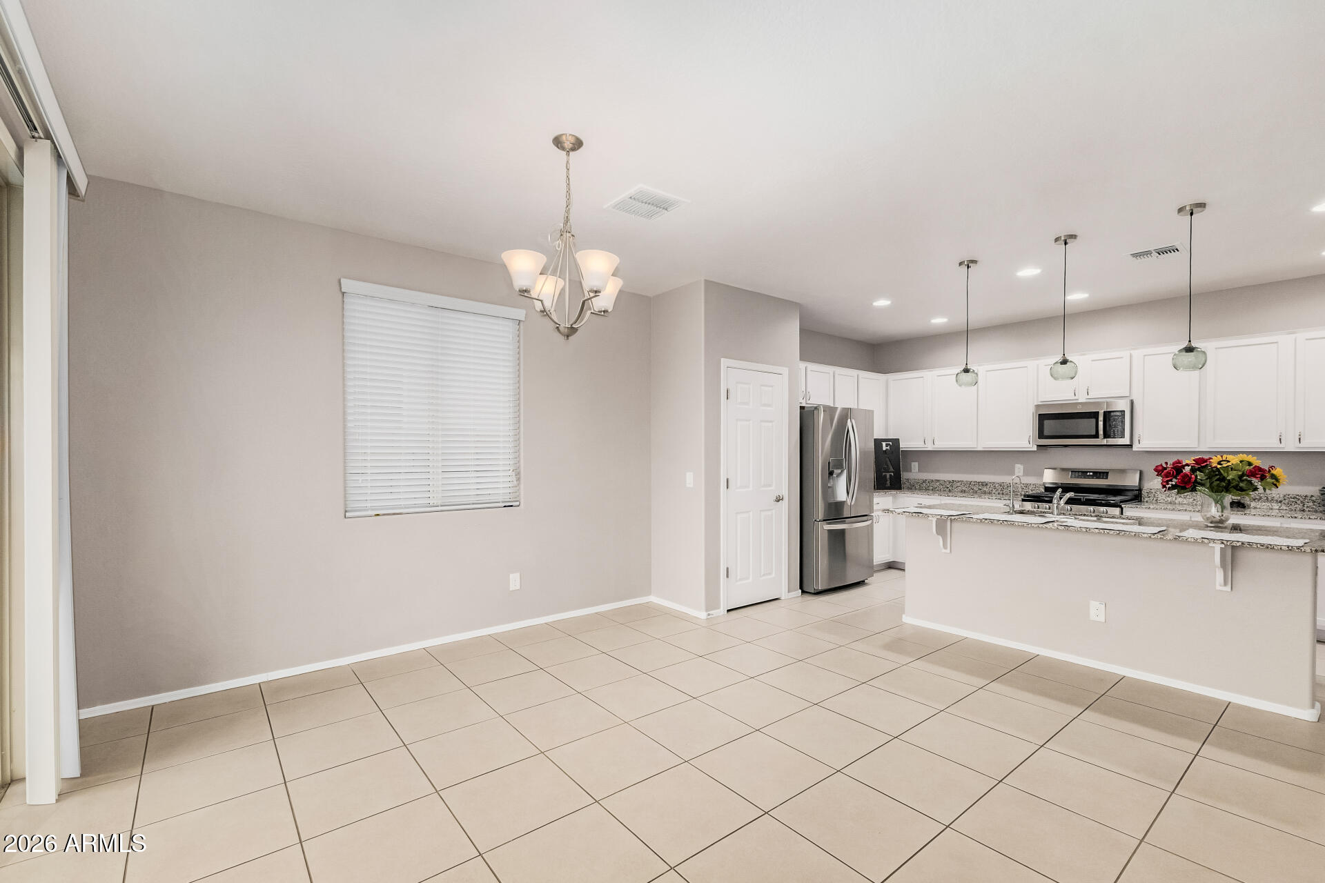 4228 West Coles Road Laveen, AZ 85339 - Photo 12 of 36 a kitchen with stainless steel appliances a refrigerator sink and microwave