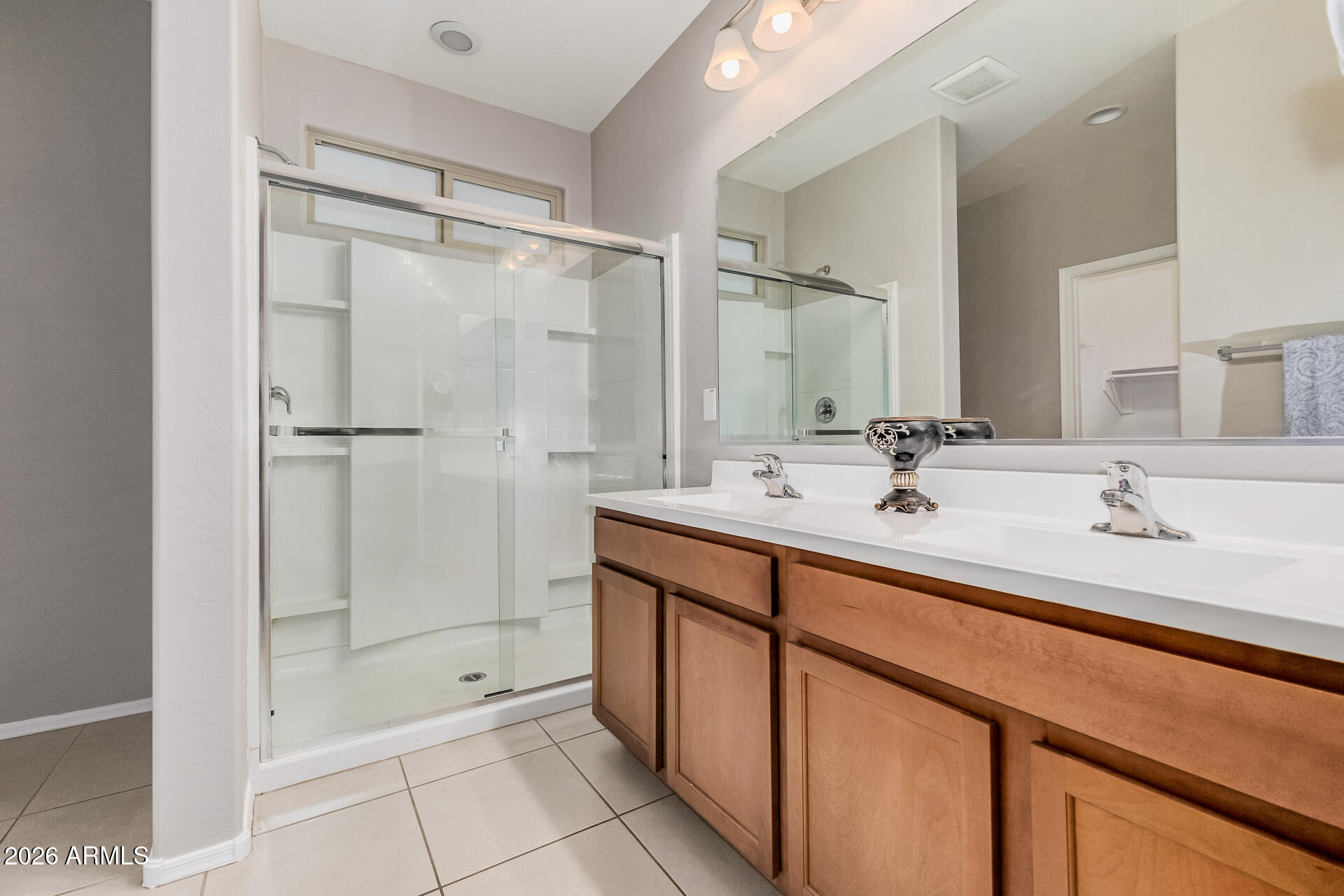 4228 West Coles Road Laveen, AZ 85339 - Photo 17 of 36 a bathroom with a double vanity sink mirror and shower