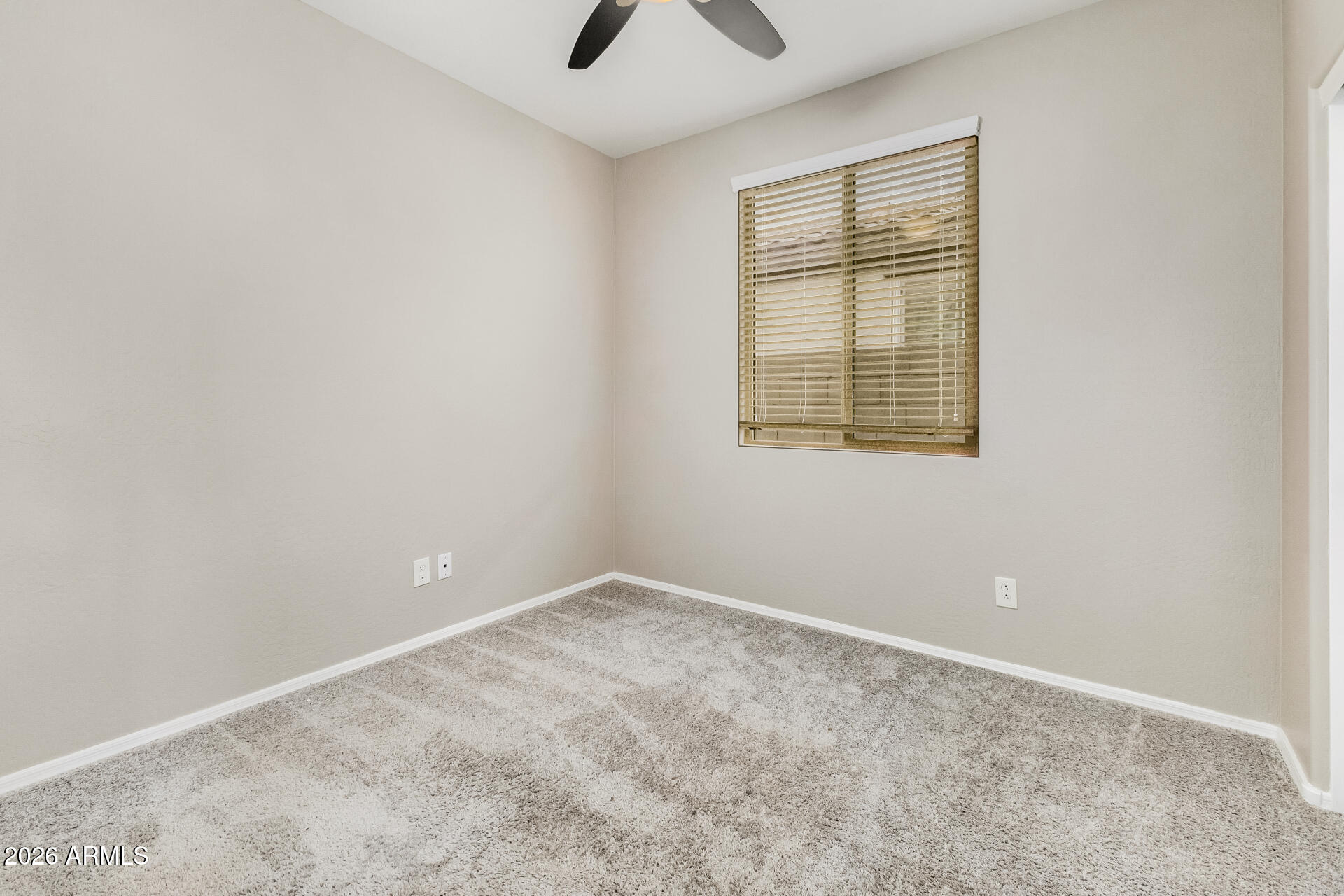 4228 West Coles Road Laveen, AZ 85339 - Photo 21 of 36 an empty room with a window and a fan